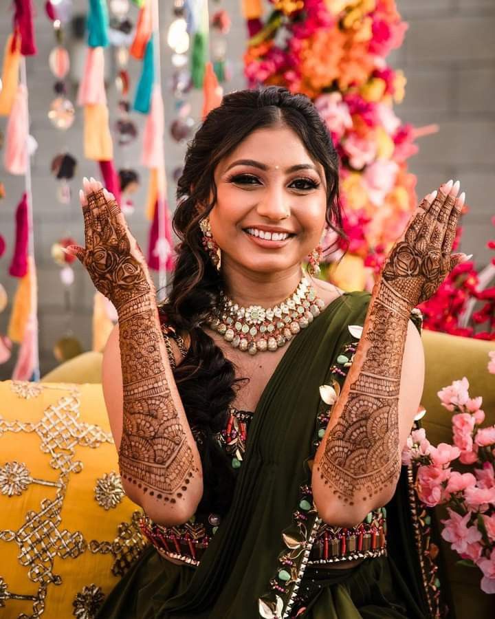 Bride showing her mehendi during wedding photoshoot